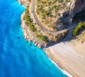 Aerial view of mountain road near blue sea with sandy beach Royalty Free Stock Photo