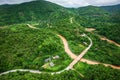 Aerial view of mountain road and river in rainy season