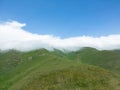 Aerial view mountain. Scenic aerial view mountain ridge. Above green landscape with sunlight mountains covered with clouds Royalty Free Stock Photo