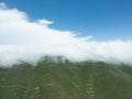 Aerial view mountain. Scenic aerial view mountain ridge. Above green landscape with sunlight mountains covered with clouds Royalty Free Stock Photo