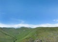 Aerial view mountain. Scenic aerial view mountain ridge. Above green landscape with sunlight mountains covered with clouds Royalty Free Stock Photo