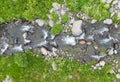 Aerial view mountain stream with colourful stones. Flowing river with smooth stones. Spring water running through different stones Royalty Free Stock Photo