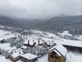 Aerial view of a Mountain Village with Hills Covered in Snow and Pine Forest in Winter. Yaremche, Ukraine. Flying over Royalty Free Stock Photo