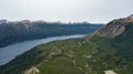 Aerial view of mountainous lake surrounded by high mountain during summer time