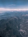 Aerial view on the mountains from the airplane window. Cloudy day. Background picture.