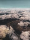 Aerial view on the mountains from the airplane window. Cloudy day. Background picture.