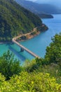 Aerial view of the mountains, lake and bridge. Road above Piva Lake Pivsko Jezero. Montenegro, Pluzine, Lake of Piva