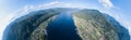 Aerial view of mouth at wide Teletskoye lake in the Altai Mountains by the blue water, sky with white clouds, green trees on the Royalty Free Stock Photo