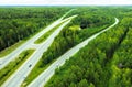 Aerial view of movement of cars on the motorway through forest