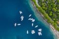 Aerial view of a much chaotically standing boats in a bay at sunset, Croatia, coastline with azure water and green trees Royalty Free Stock Photo