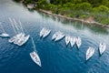 Aerial view of a much chaotically standing boats in a bay at sunset, Croatia, coastline with azure water and green trees Royalty Free Stock Photo