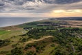 Aerial view of Muckleburgh Hill and Weybourne in Norfolk, the sun rising above Sheringham in the distance, the manmade hill in the Royalty Free Stock Photo