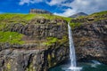 Aerial view of Mulafossur waterfall in Gasadalur village in Faroe Islands, North Atlantic Ocean. Photo made by drone from above.