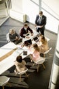 Aerial view at multiethnic group of business people working together and preparing new project on a meeting in office Royalty Free Stock Photo