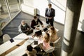 Aerial view at multiethnic group of business people working together and preparing new project on a meeting in office Royalty Free Stock Photo