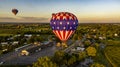 Aerial View of Multiple Hot Air Balloons Floating Up During a Morning Launch on a Sunny Summer Day