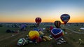 Aerial View of Multiple Hot Air Balloons Floating Up During a Morning Launch on a Sunny Summer Day