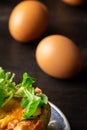 Aerial view of mushroom quiche with lamb`s lettuce and brown eggs, with selective focus,