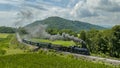 Aerial View of a Narrow Gauge Steam Passenger Train, Approaching Traveling Around a Curve