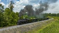 Aerial View of a Narrow Gauge Steam Passenger Train, Approaching Traveling Around a Curve