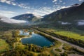 Aerial view of natural landscapes and highway asphalt road along lakes and mountains Royalty Free Stock Photo