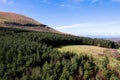 Aerial view on nature scene with green forest by a mountain, cloudy sky. Sligo area, Ireland. Warm sunny day. Country side. Irish