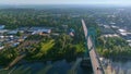 Aerial view near sunrise flying forward from middle of Willamette River, revealing dual gothic style towers of St Johns Bridge