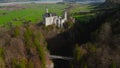 Aerial view Neuschwanstein Castle and bridge Marienbrucke across Pollat gorge in Ammergau Alps. View of famous