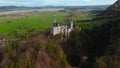 Aerial view Neuschwanstein Castle and bridge Marienbrucke across Pollat gorge in Ammergau Alps. View of famous