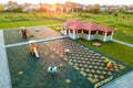 Aerial view of new alcove in kindergarten play yard with red tiled roof for outdoor children activities