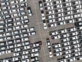 Aerial view of new cars stock at factory parking lot. Above view cars parked in a row. Automotive industry. Logistics business. Royalty Free Stock Photo