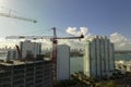 Aerial view of new developing residense in american urban area. Tower cranes at industrial construction site in Miami