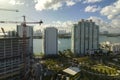 Aerial view of new developing residense in american urban area. Tower cranes at industrial construction site in Miami