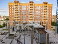 Aerial view of a new modern house under construction with a working people and equipment on the roof on the background Royalty Free Stock Photo