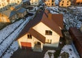 Aerial view of new residential house cottage and attached garage with shingle roof on fenced yard on sunny winter day in modern Royalty Free Stock Photo