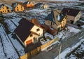 Aerial view of new residential house cottage and attached garage with shingle roof on fenced yard on sunny winter day in modern Royalty Free Stock Photo