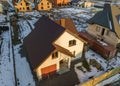 Aerial view of new residential house cottage and attached garage with shingle roof on fenced yard on sunny winter day in modern Royalty Free Stock Photo