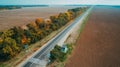 Aerial view of the new road, autumn trees and blue sky