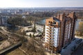 Aerial view of new tall apartment building in quiet area on background of developing city landscape under bright blue sky Royalty Free Stock Photo