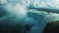 Niagara Falls Aerial View Powerful Waterfall Plunge and Misty Spray Under Cloudy Sky Royalty Free Stock Photo