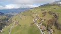 Aerial view, nice cottages on picturesque mountain slope, downshifting, tourism