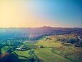 Aerial view of nice landscape of rustic houses and green meadows in autumn Royalty Free Stock Photo