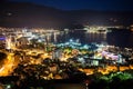 Aerial view at night colorful Budva city. The central modern part with sea shore and port in Budvanska riviera. Montenegro, Europe Royalty Free Stock Photo