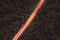 Aerial view of night green forest,  road and cars passing by. Royalty Free Stock Photo