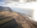 Jagged coasts and cliffs overlooking the ocean. Aerial view. Lanzarote, road leading to the Mirador del Rio.