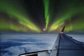 Aerial view of Northern Lights Aurora Borealis from window of an flying airplane