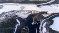 Aerial view at northern rail road passing along partially frozen lake in forest on cold winter day, north Karelia, Russia Royalty Free Stock Photo