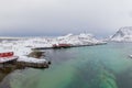 Aerial view of Norwegian fishing village in Reine City, Lofoten islands, Nordland, Norway, Europe. White snowy mountain hills, Royalty Free Stock Photo