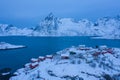 Aerial view of Norwegian fishing village in Reine City, Lofoten islands, Nordland, Norway, Europe. White snowy mountain hills, Royalty Free Stock Photo