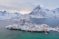 Aerial view of Norwegian fishing village in Reine City, Lofoten islands, Nordland, Norway, Europe. White snowy mountain hills, Royalty Free Stock Photo